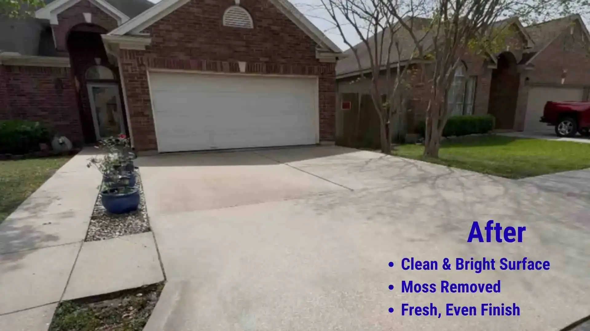 After driveway cleaning showing a bright, clean concrete driveway in front of a brick home with moss removed and an even surface finish in Eugene, Oregon.